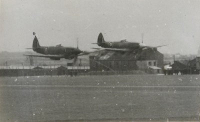  2 Seafires(?) low-level flying 